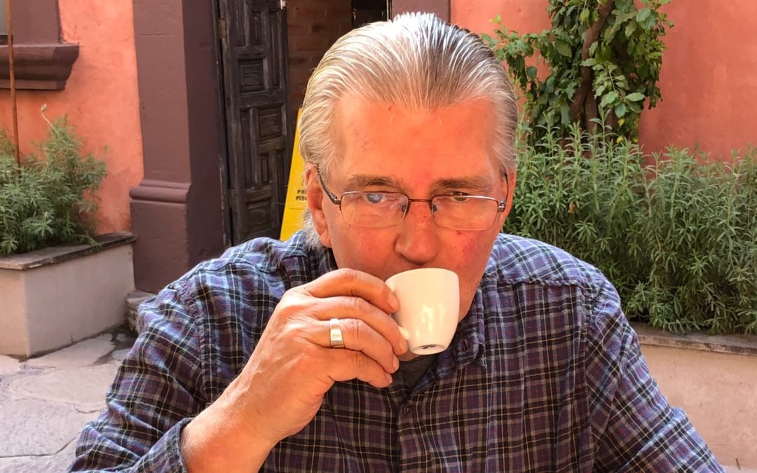 A very good cup of coffee and a very excited guy.